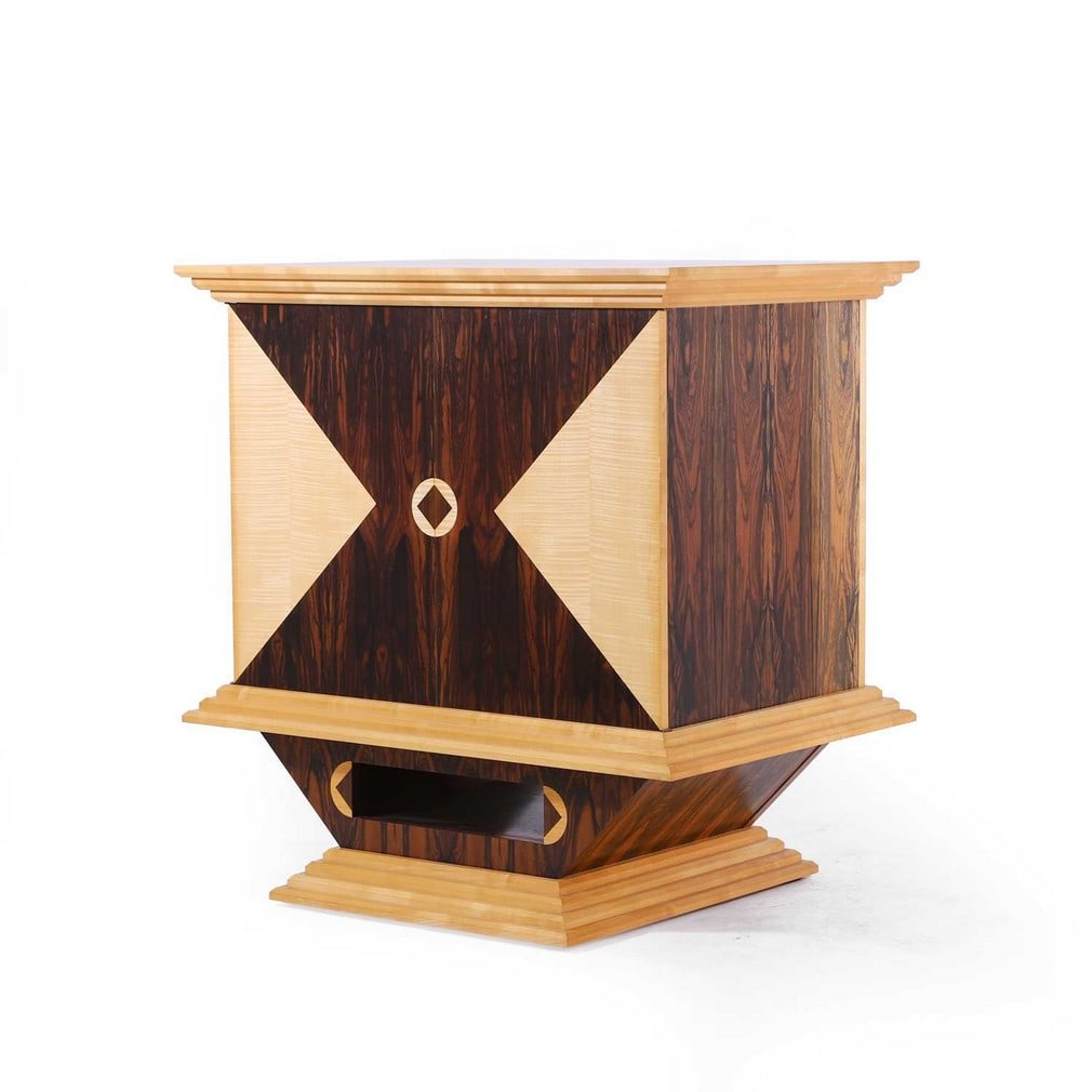 § ▲ Sean Feeney (British, b.1956), a sycamore and rosewood cabinet,: § ▲ Sean Feeney (British, b.1956), a sycamore and rosewood cabinet, circa 1991, Art Deco style, the upper section with two doors decorated with geometric inlays, over a waisted stand and re