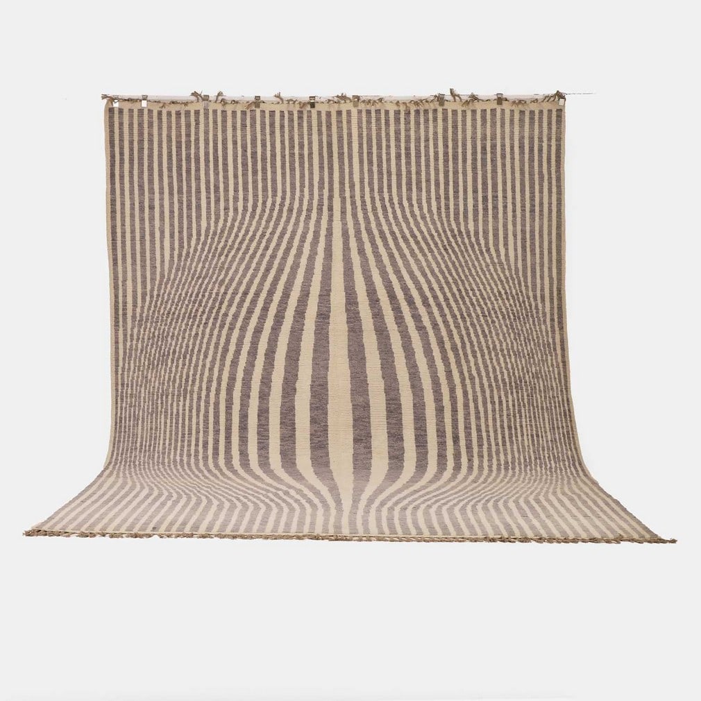 After Victor Vasarely, an 'Atlas Mountains' carpet,: After Victor Vasarely, an 'Atlas Mountains' carpet, of recent manufacture, woven in a repeating geometric pattern in tones of cream and grey (441 x 301cm)