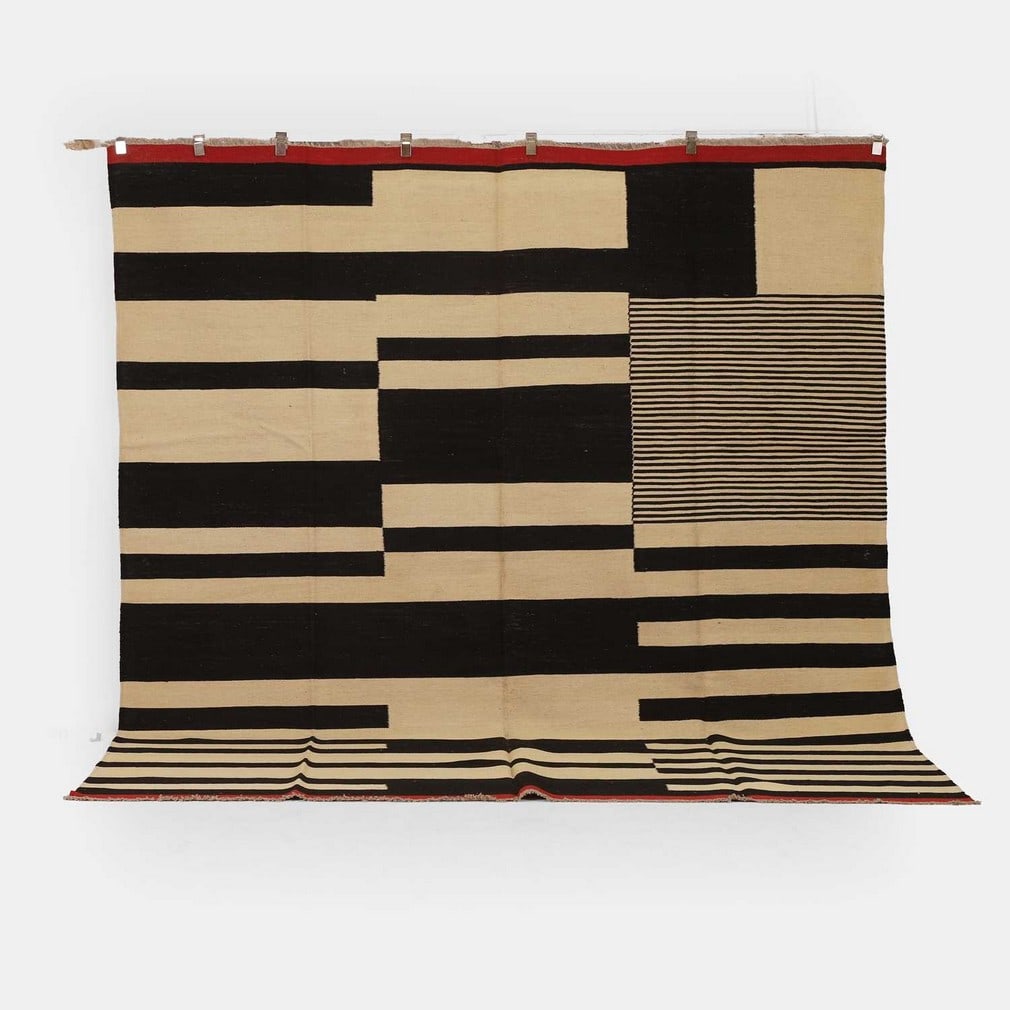 Bauhaus inspired, a flat-weave kilim,: Bauhaus inspired, a flat-weave kilim, of recent manufacture, woven with various stripes in tones of black, red and cream (307 x 260cm)