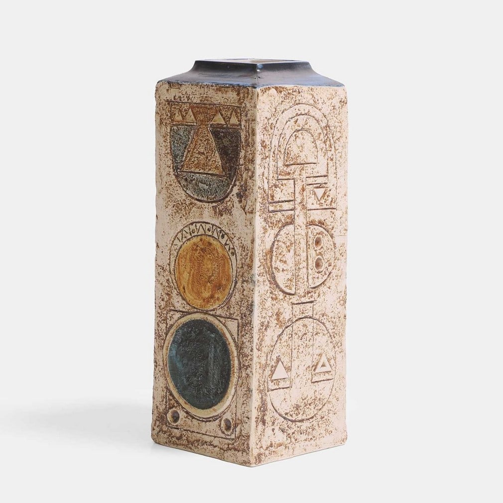 Eleanor Winning for Troika Pottery, a square-form vase,: Eleanor Winning for Troika Pottery, a square-form vase, of shouldered form, cast in low relief with geometric panels, in shades of blue and buff, painted marks and artist's monogram 'EW' (11cm wide, 1