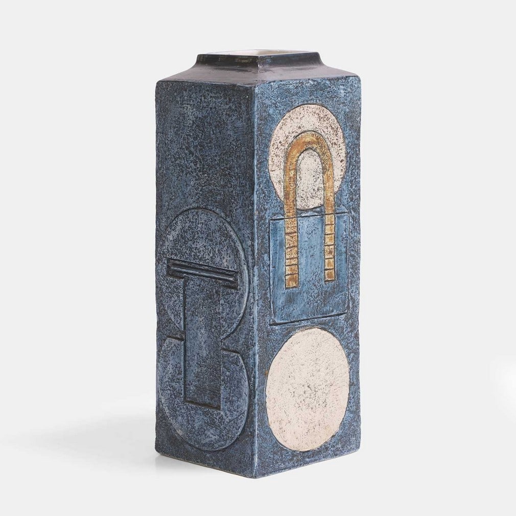 Anne Lewis for Troika Pottery, a square form vase,: Anne Lewis for Troika Pottery, a square form vase, of shouldered form, cast in low relief with geometric panels, in shades of blue and buff, painted marks and artist's monogram 'AL' (12cm wide, 10,5cm
