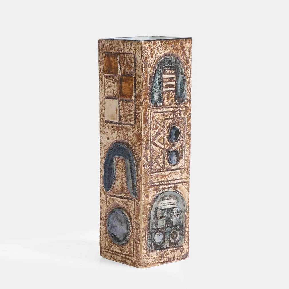 Troika Pottery, a vase,: Troika Pottery, a vase, of tall square form, cast in low relief with geometric panels, in shades of blue and buff, painted marks and artist's monogram 'ND(?)' (6.5cm wide, 7cm deep, 22.3cm high) Prove
