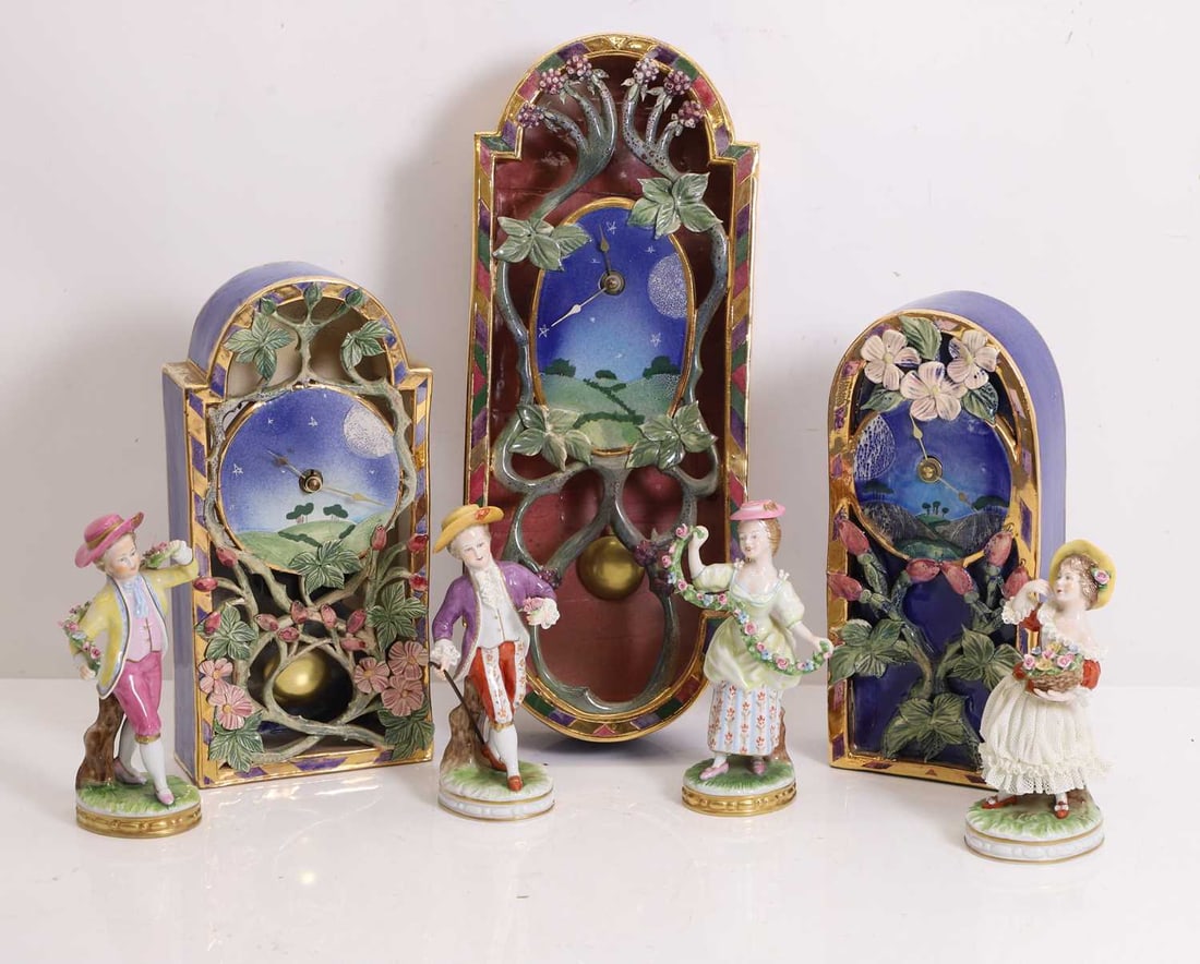 Michelle Ohlson (Contemporary) of recent manufacture,: Michelle Ohlson (Contemporary) of recent manufacture, three studio ceramic glazed clocks, one wall-mounted, with battery movements, together with four Unter Weiss Bach figures of children 39cm, 27cm