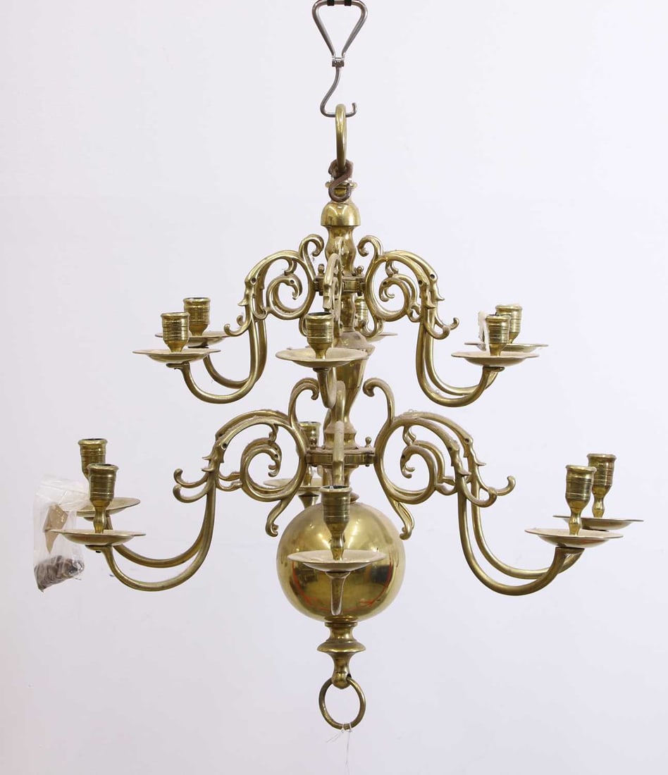 A brass chandelier, 20th century,: A brass chandelier, 20th century, in the Dutch/Flemish style, with a baluster central stem and knopped body, issuing scrolling S-form branches arranged on two tiers and fitted with circular drip-pans