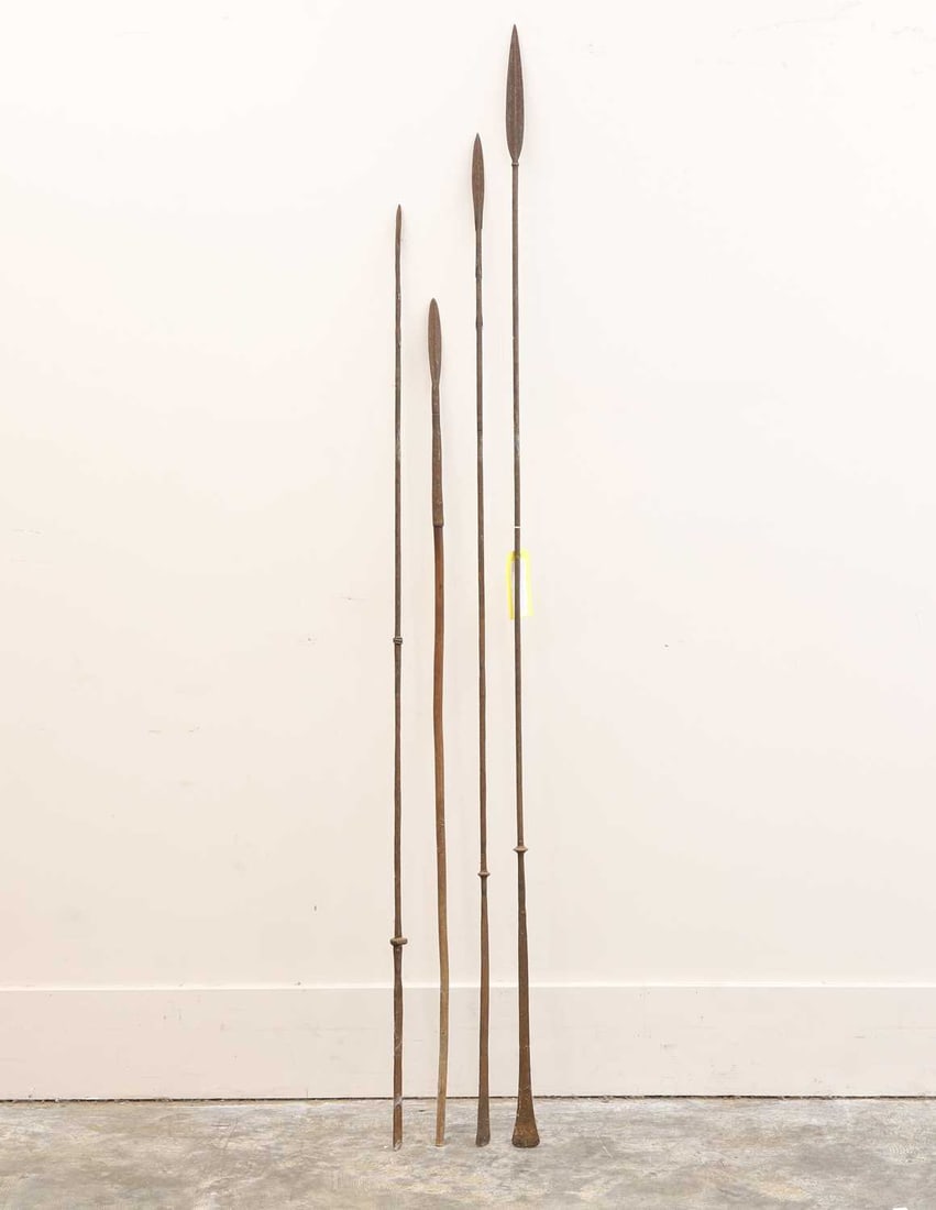 Four tribal iron spears, Probably 19th/20th century,: Four tribal iron spears, Probably 19th/20th century, two with barbed heads, one with a wood shaft, the others with flattened ends 192cm longest4Condition Report: Worn, with rust