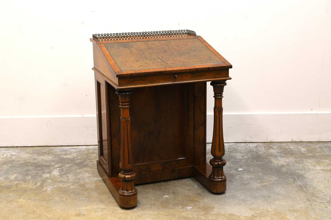 A William IV rosewood Davenport desk, circa 1830,: A William IV rosewood Davenport desk, circa 1830, with brass gallery above rising tooled leather slope to panelled side cabinet opening to reveal flight of four drawers supported on a platform base w