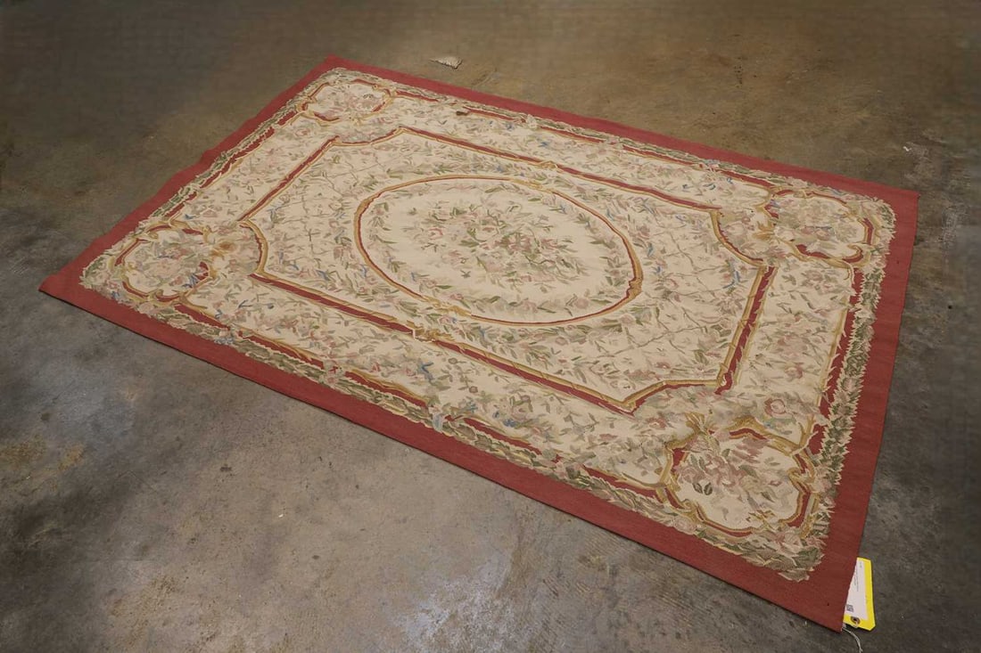 A French Aubusson-style tapestry panel, 20th century,: A French Aubusson-style tapestry panel, 20th century, of rectangular form, with a central oval medallion, enclosing a bouquet of flowers, within a field of trailing floral sprays, framed by a shaped