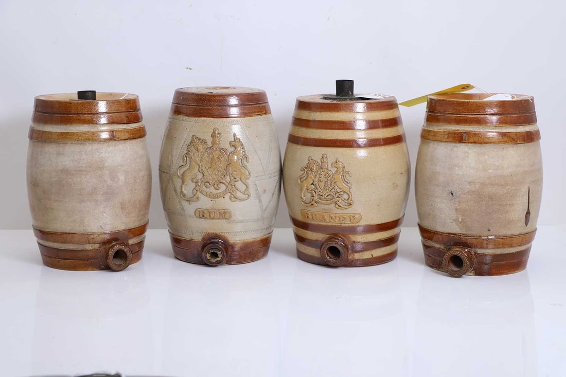 A group of four novelty liquor barrels, late 19th century,: A group of four novelty liquor barrels, late 19th century, comprising Rum and Brandy, marked Doulton & Watts, each with Royal Coat of Arms, together with a plain banded example impressed with
