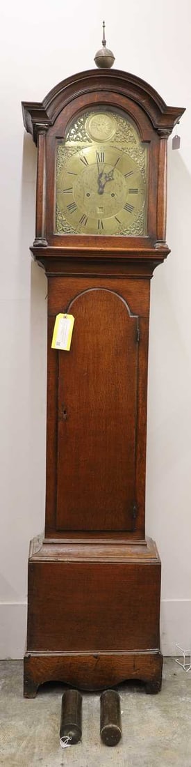 A George III oak eight day longcase clock, mid to late 18th century,: A George III oak eight day longcase clock, mid to late 18th century, by Will Peacock of Kimbolton, the brass dial with Roman numeral chapter ring, engraved center, celestial sun and foliate scroll ca