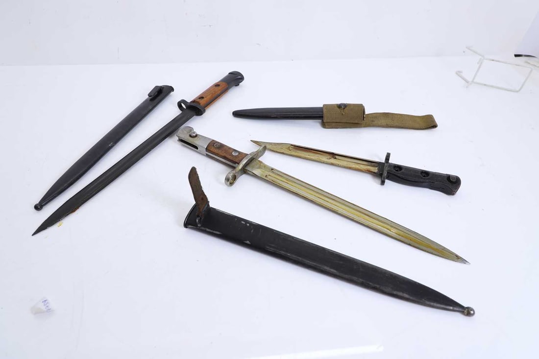 A group of three bayonets, 19th to 20th century,: A group of three bayonets, 19th to 20th century, comprising a British No.5 mark II jungle carbine bayonet with scabbard and frog, the blade of compact form, the steel socket with locking mechanism an