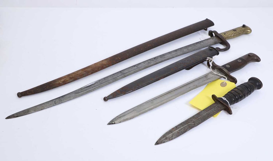 A French Chassepot bayonet, model 1868 20th century,: A French Chassepot bayonet, model 1868 20th century, with characteristic yataghan-shaped blade formed with a broad fuller, the spine inscribed with arsenal and 1868, ribbed brass grip secured by