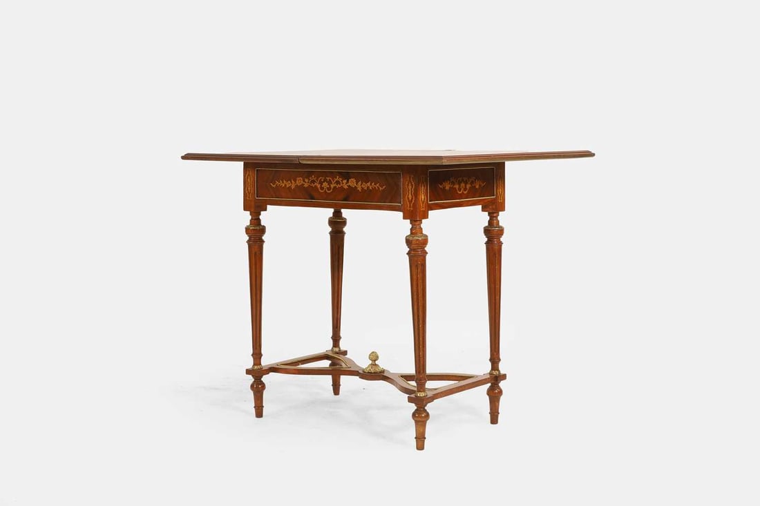 A Louis XVI-style walnut, marquetry and penwork games table, first half of the 20th century, French,: A Louis XVI-style walnut, marquetry and penwork games table, first half of the 20th century, French, the folding rectangular top with floral inlay, enclosing a baize-lined playing surface, with a con