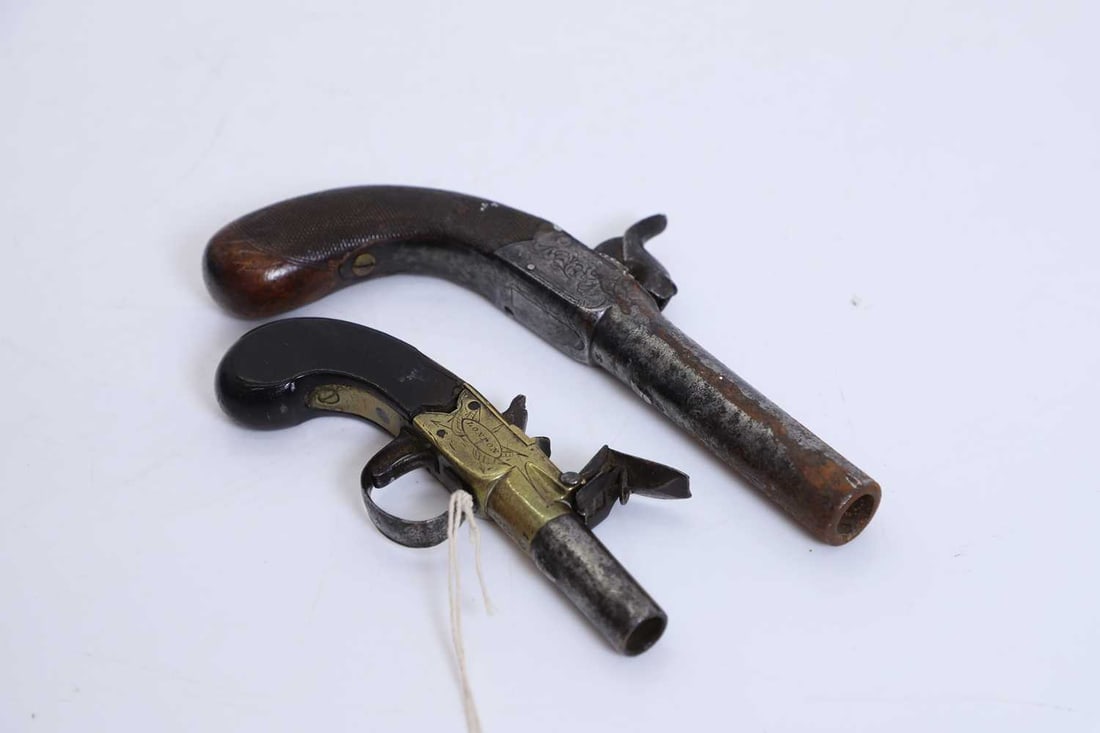 A flint lock pocket pistol, mid 19th century, London,: A flint lock pocket pistol, mid 19th century, London, with turn-off steel barrel of small calibre, the brass sides engraved with foliate scrollwork and signed within an oval cartouche 'Riviere London