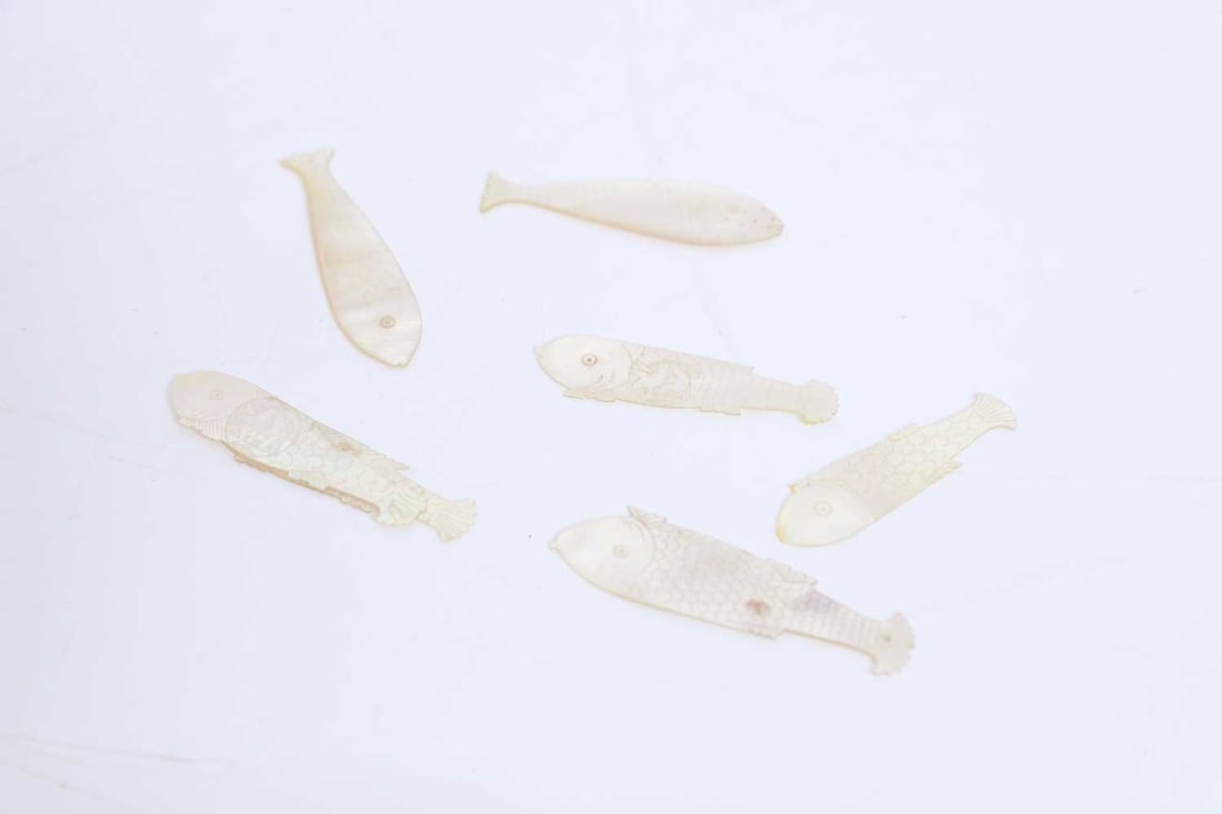 A collection of mother of pearl Chinese gaming counters, 19th century,: A collection of mother of pearl Chinese gaming counters, 19th century, of various forms and shapes to include fish-shaped, lozenge-shaped, and larger examples, with carved decoration throughout, appr