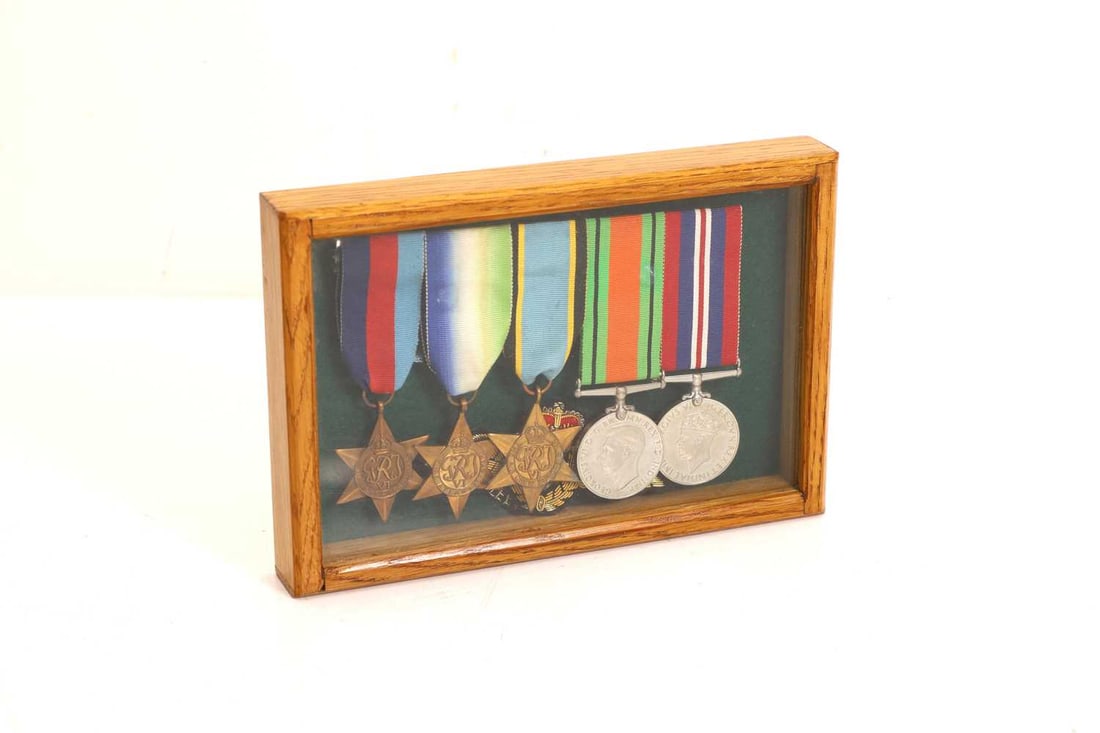 A George VI World War II medal group,: A George VI World War II medal group, comprising a 1939-1945 star, The Atlantic medal, The Air Crew Europe star, the Defence and War medal, with a Fleet Arm cloth badge, mounted in a case 22 x 15cm1C
