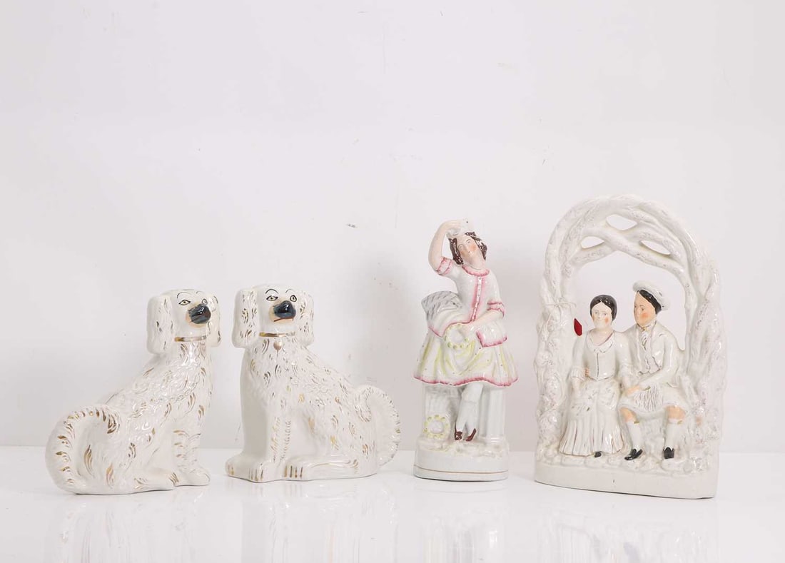 A Staffordshire pottery group, 19th century,: A Staffordshire pottery group, 19th century, a pair of dogs, a figure, and a pair under an arch 23cm wide, 32cm high, 8cm deep, 4 Provenance: The Select Contents of a Provincial French Estate.