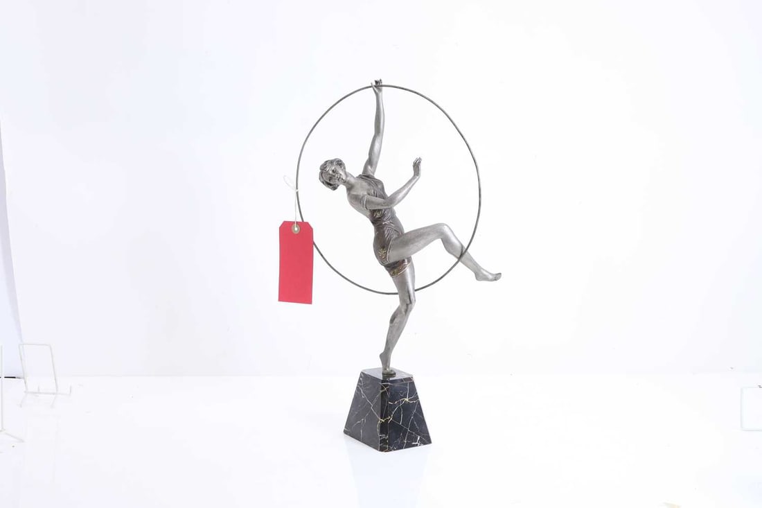 An Art Deco style figure, 20th century,: An Art Deco style figure, 20th century, modelled as s silvered woman holding a hoop, stamped MADE IN FRANCE 50cm high