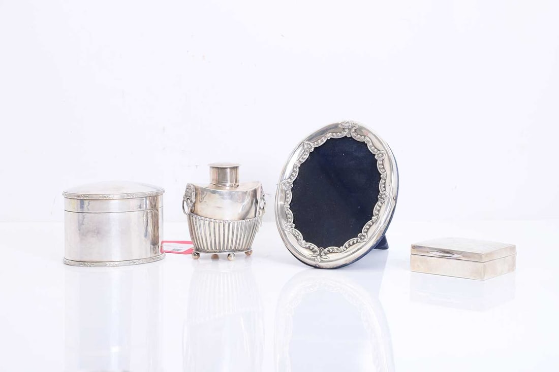 A collection of silver items, 19th century and later,: A collection of silver items, 19th century and later, comprising a tea canister, by Alfred James How, London 1898, a silver cigarette box, marks rubbed, and a photograph frame, by William Comyns