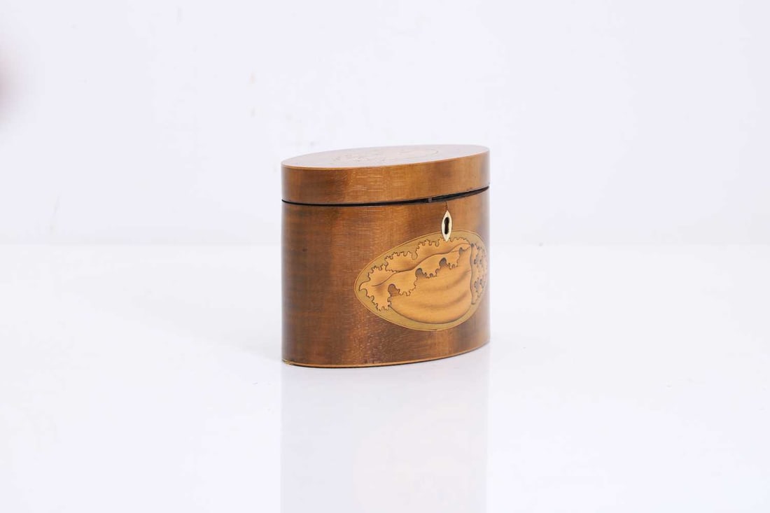 An oval mahogany tea caddy, (1 of 4)