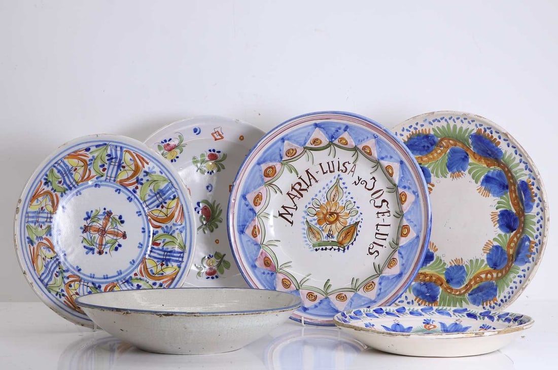 A collection of Spanish plates and bowls, 18th to 19th century,: A collection of Spanish plates and bowls, 18th to 19th century, painted in polychrome, decorated with floral motifs Largest 39cm diameter qty. Provenance: The Select Contents of a Provincial French