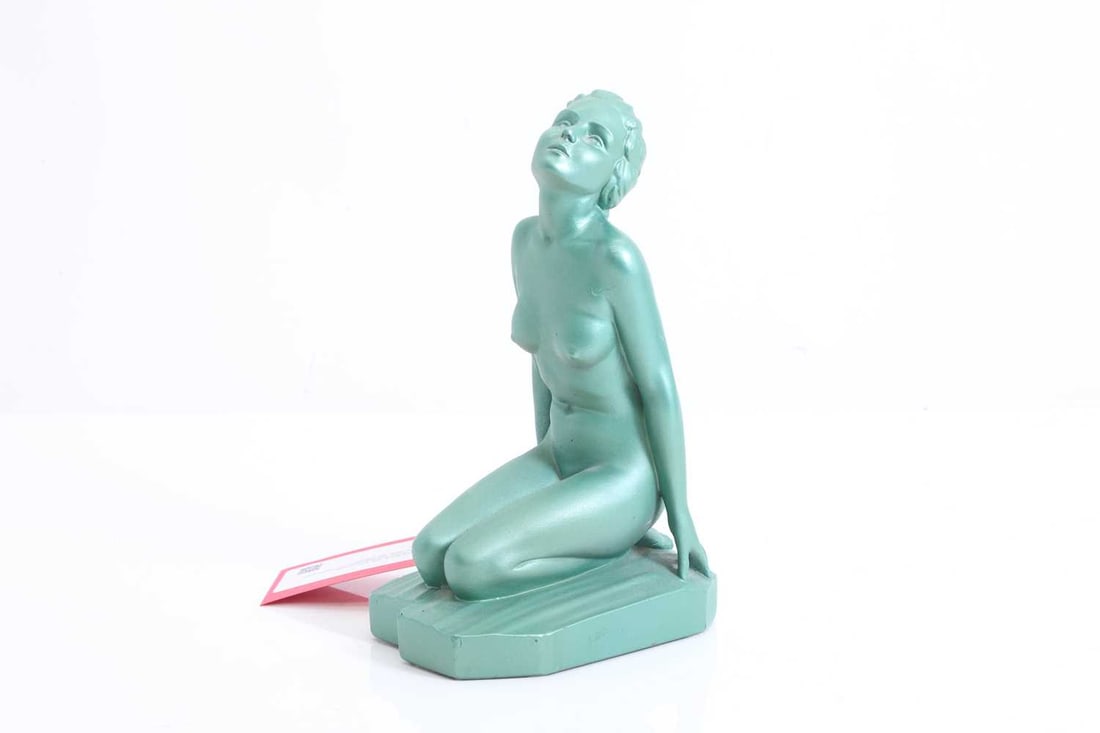 An Art Deco plaster nude figure, late 20th century,: An Art Deco plaster nude figure, late 20th century, kneeling, on a textured colour matched base, with registration number to the rear of the base, RD.809463 24cm high, 16.5cm wide