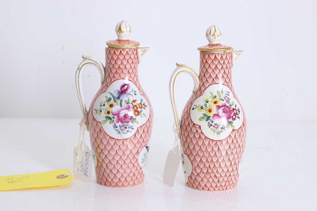 A pair of small porcelain ewers and covers, 19th century,: A pair of small porcelain ewers and covers, 19th century, in the Bristol style, each with quatrefoil reserves containing floral bouquets and birds, on a fish scale ground 19.5cm high 4 