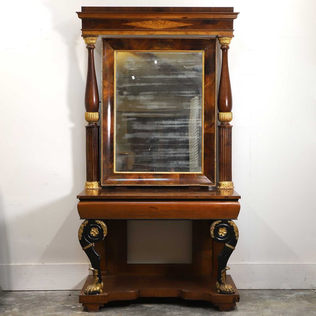 A mahogany and parcel gilt console table and mirror, late 19th century,: A mahogany and parcel gilt console table and mirror, late 19th century, the rectangular mirror plate within a moulded mahogany frame flanked by turned and tapering columns with gilt capitals,