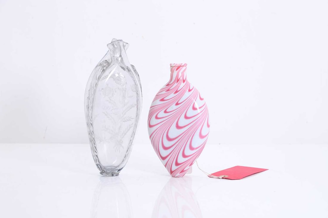 A Nailsea-type glass gimmel flask, late 18th century,: A Nailsea-type glass gimmel flask, late 18th century, with a double spout and feather decoration, one side etched with sunflowers, the other with swags and garlands, inscribed 'TPs INs Surv Ah',