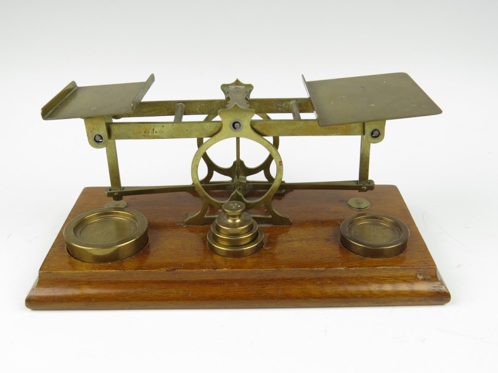Sampson Mordan & Co., a set of brass postal scales, c.: Sampson Mordan & Co., a set of brass postal scales, c.1890-1900, the beam stamped 'S. Mordan & Co, London', with five weights, 1oz - 8oz, housed within three apertures, 10.5cm high