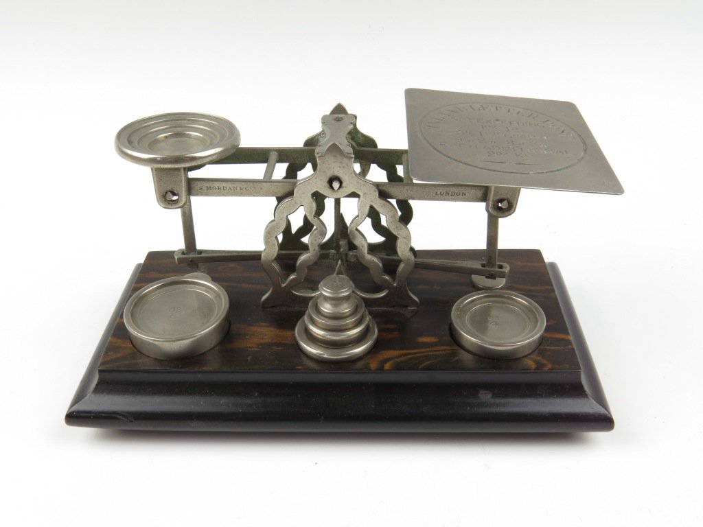 Sampson Mordan & Co., a nickel plated postal scale, c.: Sampson Mordan & Co., a nickel plated postal scale, c.1871-1885, the beams stamped 'S. Mordan & Co, London', upon a pierced shaped 'A' frame, above a Coromandel veneered base with bun feet, with three