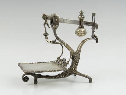 Meriden SX, a rare American decorative silver plated s: Meriden SX, a rare American decorative silver plated spelter steelyard, late 19th century, the beam struck 'Fairbanks', with decorative sliding poise, supported within an ornate foliate decorated fram