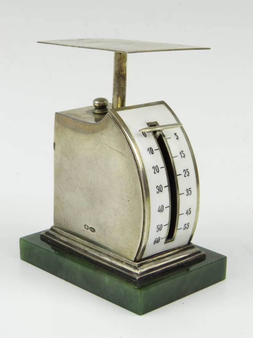 An Austrian silver bow front letter scale, c.1907, wit: An Austrian silver bow front letter scale, c.1907, with white enamel dial, 0-60 and 5-55, the right hand side panel being removable in order that the mechanism can be inspected, upon a green marble re
