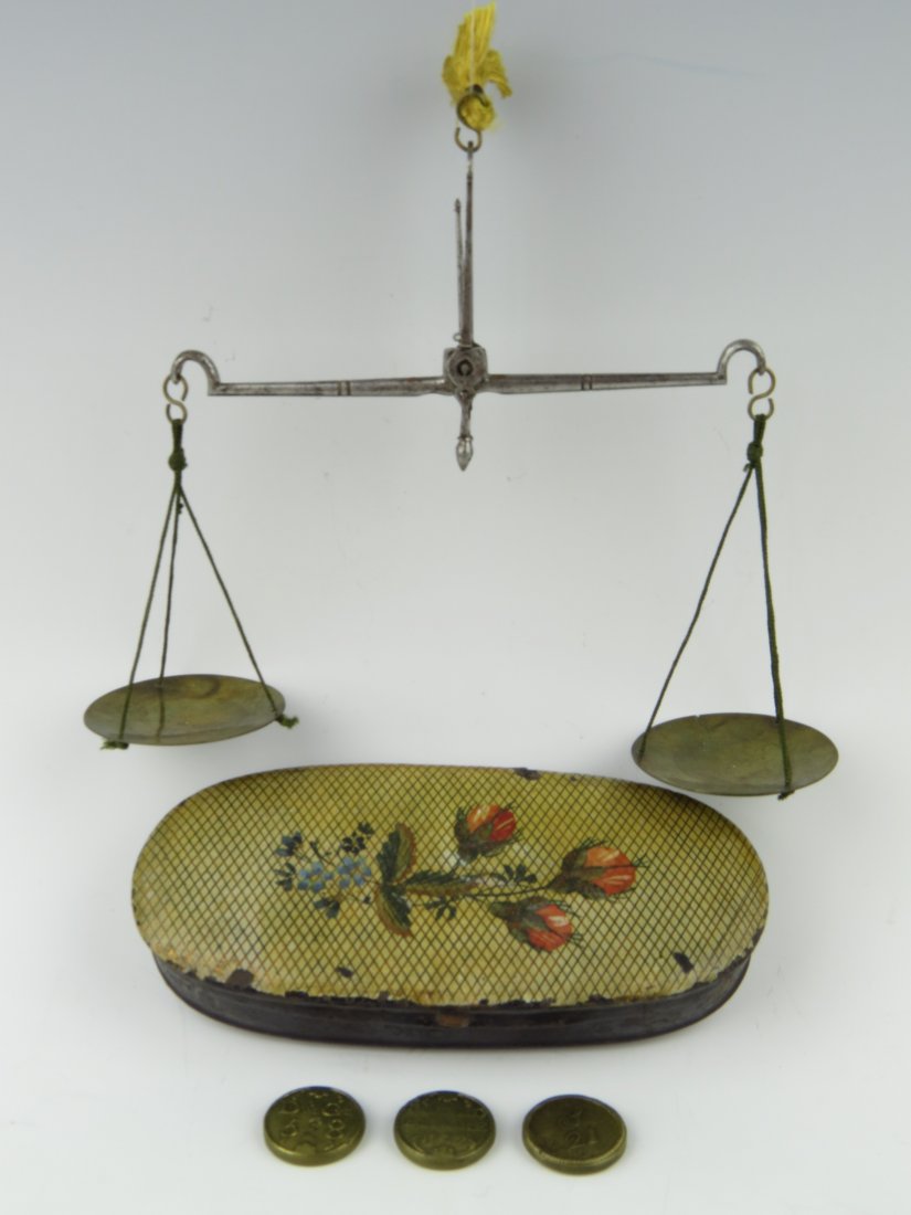 George III coin scales, c.1780, the turned beam with s: George III coin scales, c.1780, the turned beam with swan neck ends, within a japanned and hand painted oval case, the lid hand painted with roses, with two George III guinea weights, each struck with