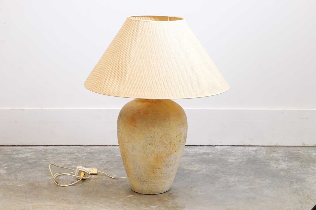 A large terracotta table lamp, of modern manufacture,: A large terracotta table lamp, of modern manufacture, with a turned design and rattan shade 29cm wide, 53cm high Condition Report: We cannot guarantee the full working order of this item and would