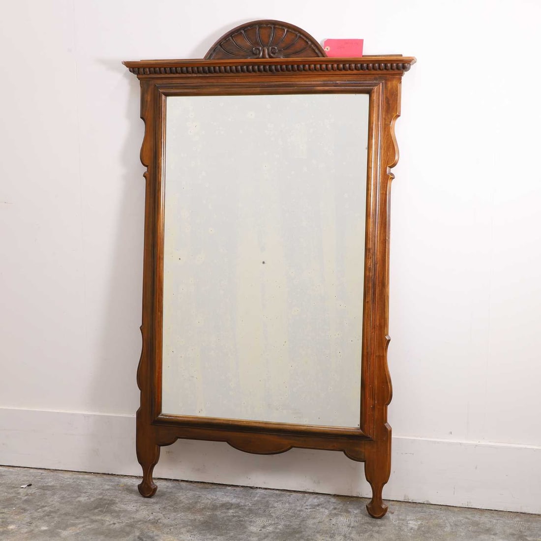A large Spanish walnut pier mirror, late 19th / early 20th century,: A large Spanish walnut pier mirror, late 19th / early 20th century, with a shaped and carved frame surrounding a rectangular plate 150cm high 80cm wide Provenance: The Select Contents of a Provincial 