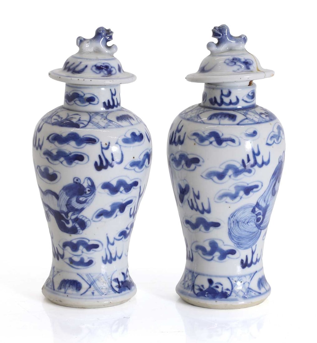 A pair of Chinese blue and white vases and covers, late 19th century,: A pair of Chinese blue and white vases and covers, late 19th century, of og baluster form with blue and white decoration of dragons amongst clouds, and four character mark to base 7cm wide, 17cm high