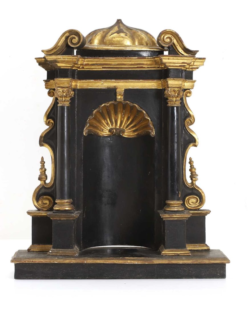 A Spanish shrine, 18th century,: A Spanish shrine, 18th century, of baroque architectural form, with broken swan neck pediment, and gilded shell recess encased by a pair of columns 37cm wide, 10cm deep, 45cm high Condition Report:
