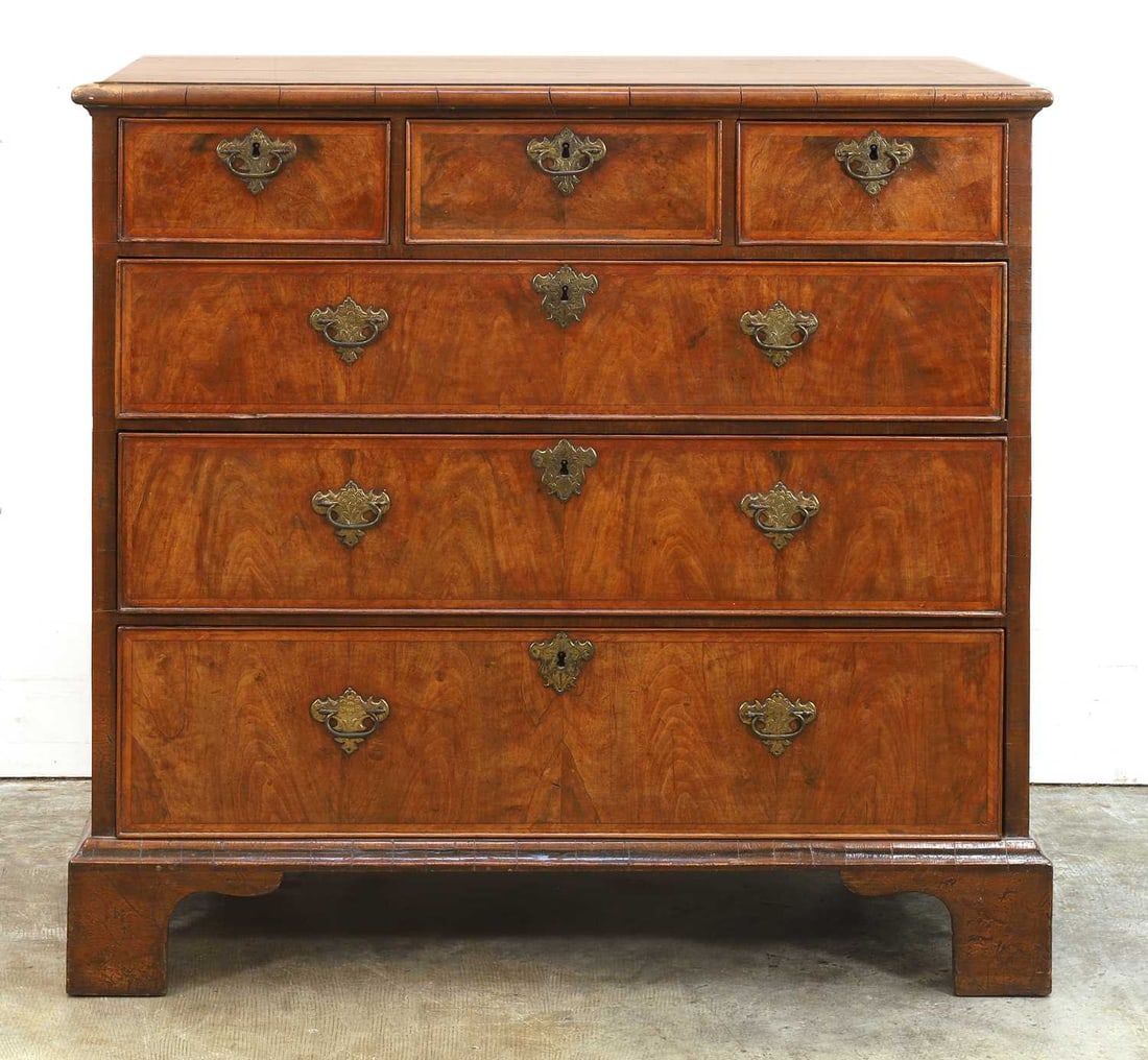 A walnut chest of drawers, first quarter of the 18th century, (1 of 2)