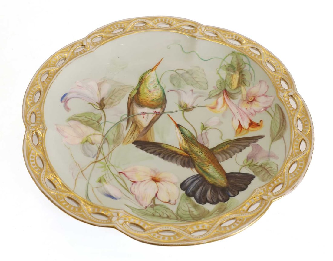 A porcelain tazza, late 19th century,: A porcelain tazza, late 19th century, decorated with Hummingbirds to a pierced gilt border 24cm diameter, 7cm wide