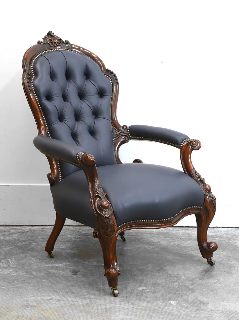 A mid-Victorian mahogany Gentleman’s armchair, c.1850,: A mid-Victorian mahogany Gentleman’s armchair, c.1850, carved show wood frame, on scroll legs and casters, with newly upholstered blue leather covering 65cm wide, 68cm deep, 99cm high