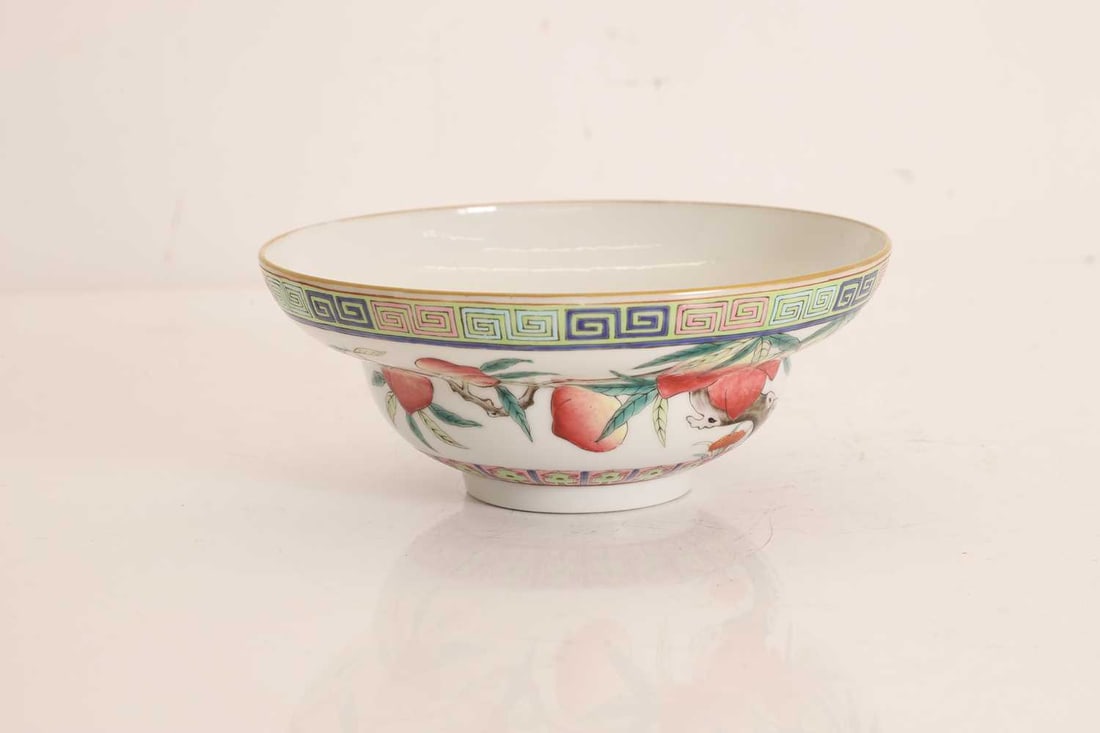 A Chinese enamelled bowl,: A Chinese enamelled bowl, potted with ogee sides rising from a short foot, decorated with peaches, lingzhi, and bats, with a blue four-character mark to base 17cm diameter