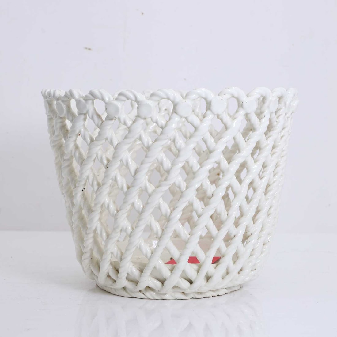 A Spanish white glazed porcelain reticulated planter 19th to 20th century,: A Spanish white glazed porcelain reticulated planter 19th to 20th century, of tapering circular form, the sides modelled in an openwork lattice of intertwined rope-twist strands, with a scalloped rim