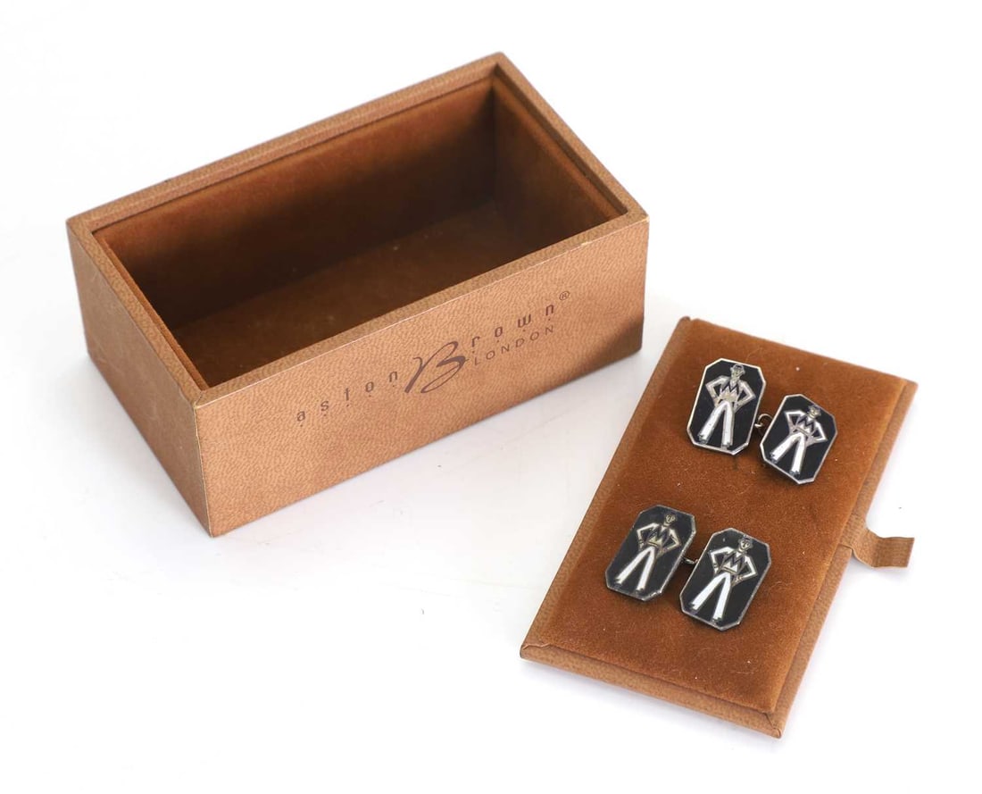 A pair of Marconi Men silver cufflinks,: A pair of Marconi Men silver cufflinks, with an enamelled design to the front stamped on the back 'SILVER', cased in a brown leather box 1.8cm long 2