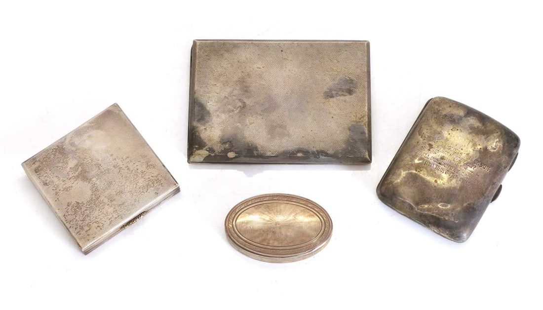 A pair of cigarette cases and a compact,: A pair of cigarette cases and a compact, on rectangular example by William Hair Haseler Birmingham, 1951, with a similar compact, A small oval shaped case, with rippling etched shell pattern and art