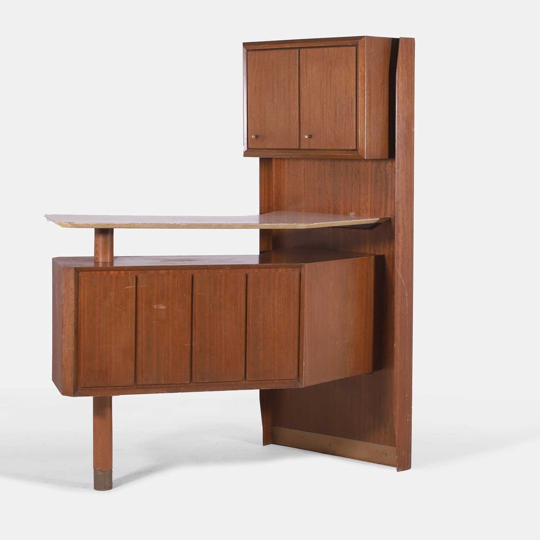 Turnidge of London, a teak cocktail bar,: Turnidge of London, a teak cocktail bar, circa 1970s, comprising a cupboard to the top with a folding door, opening to reveal a single glass shelf, the main bar with an upper white Formica shelf, with