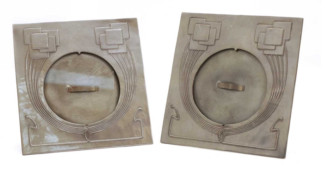A pair of Art Nouveau pewter photograph frames, 20th century,: A pair of Art Nouveau pewter photograph frames, 20th century, each of square form with circular aperture, cast in relief with stylised geometric ornament and linear motifs in the Secessionist taste,