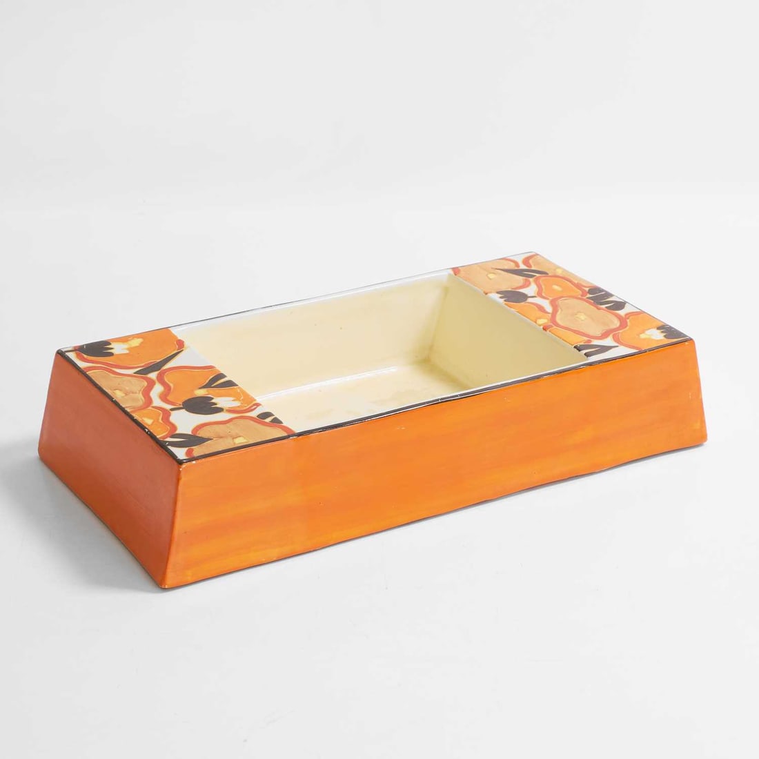 Clarice Cliff (British, 1899-1972), a rare 'Orange Chintz' double-sided bowl,: Clarice Cliff (British, 1899-1972), a rare 'Orange Chintz' double-sided bowl, circa 1930, of shallow rectangular form with sloping sides, decorated with stylised flowers in tones of orange, ochre,