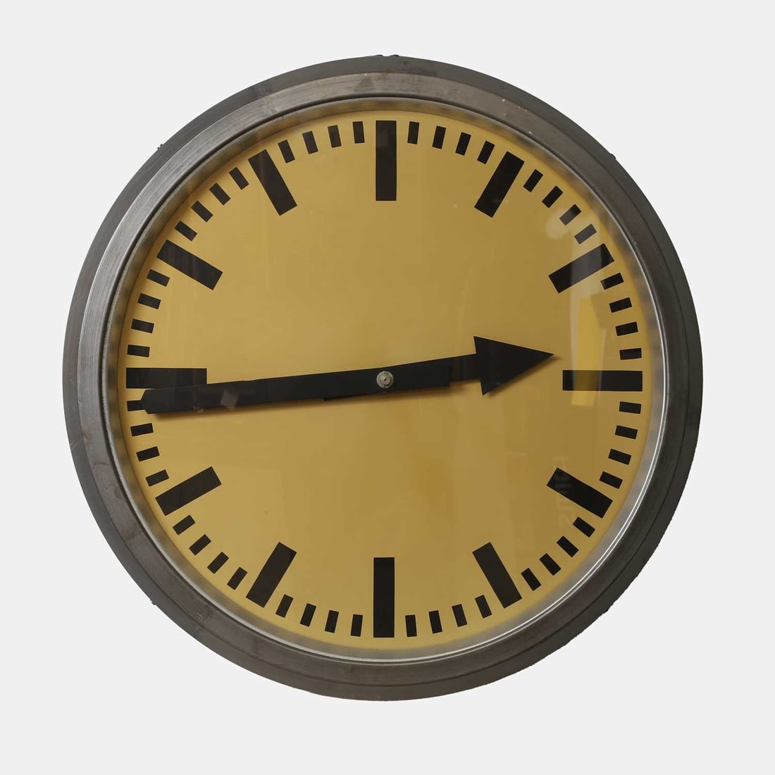 Elfema, an electrical impulse clock,: Elfema, an electrical impulse clock, 1950s, German, with an ivory-coloured face, with black metal hands and digits, in a galvanised metal casing, with applied manufacturer's label 75cm diameter, 11cm 