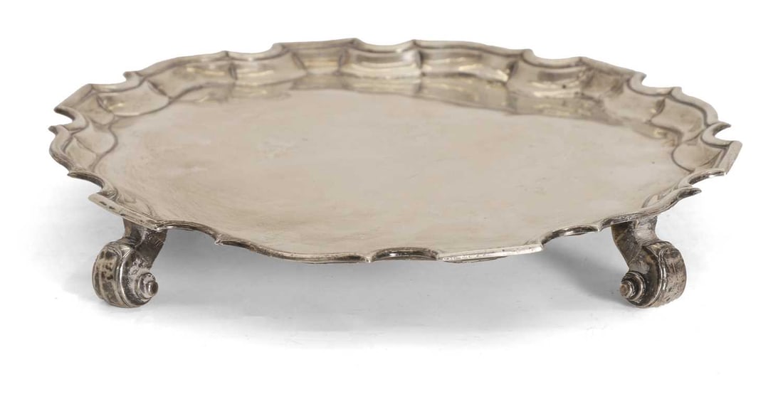A George III silver salver, by Denis Langton, London, 1733,: A George III silver salver, by Denis Langton, London, 1733, of shaped circular form, engraved 'H+NB' 26.5cm diameter, 19ozt Condition Report: Some rubbing to the marks, tarnishing. Repair to two