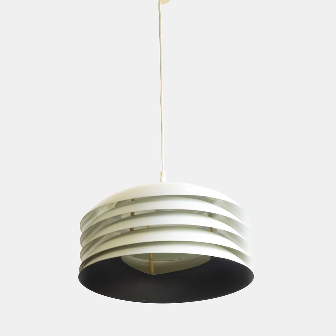 Hans-Agne Jakobsson (Swedish, 1919-2009) for Markaryd, a model 'T742' pendant light,: Hans-Agne Jakobsson (Swedish, 1919-2009) for Markaryd, a model 'T742' pendant light, circa 1960s, with a layered white-enamelled metal shade, with a black-coated underside, with applied manufacturer's